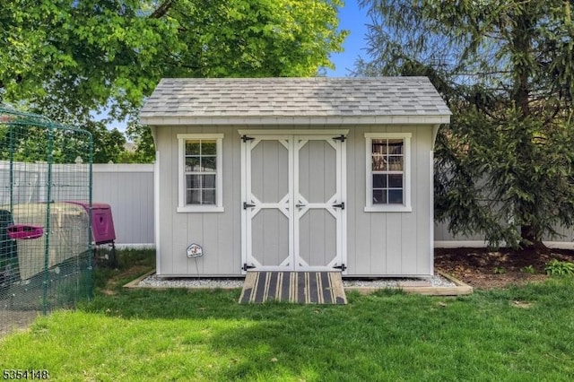 view of shed featuring fence