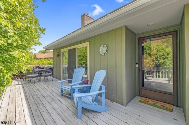wooden terrace featuring outdoor dining area