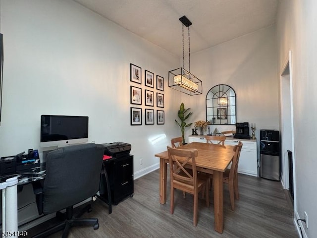 dining space featuring baseboards and dark wood-style floors
