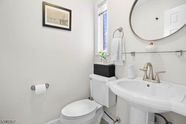 bathroom featuring baseboards and toilet