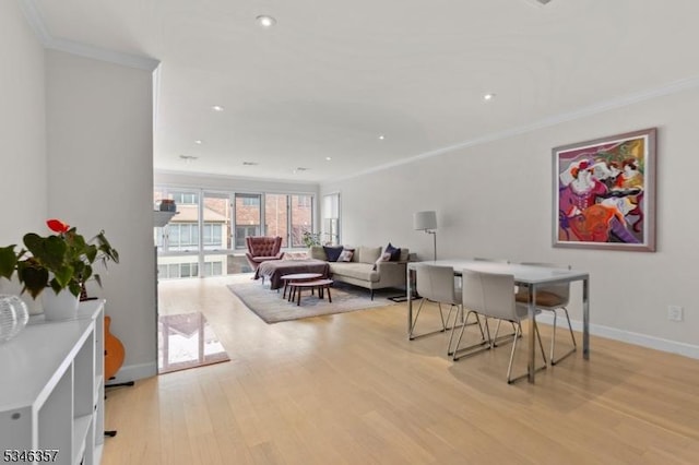 dining area featuring crown molding, baseboards, light wood-style floors, and recessed lighting