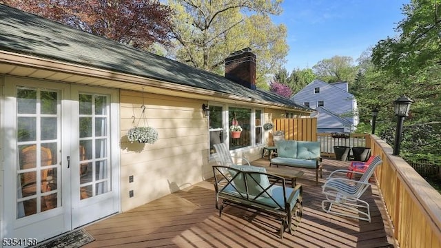 wooden terrace with french doors and outdoor lounge area