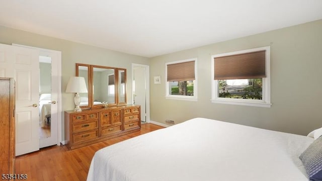 bedroom featuring light wood-type flooring and baseboards