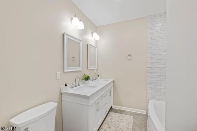 full bath featuring a sink, a washtub, toilet, and double vanity