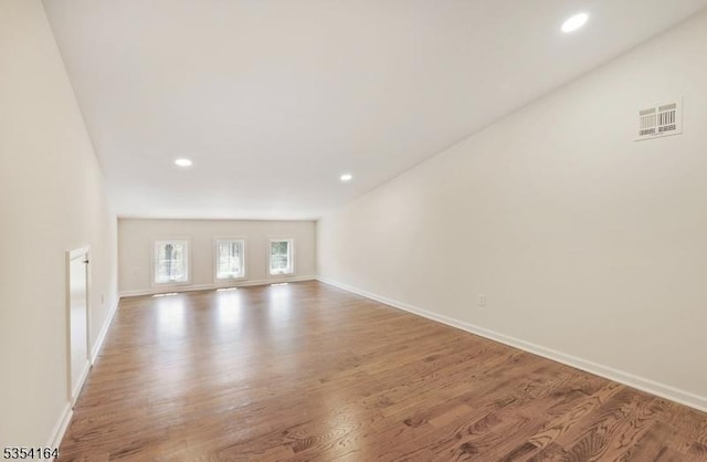 unfurnished living room featuring baseboards and visible vents