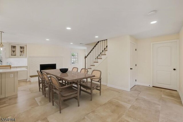 26 Woodland Rd, Mendham Twp, NJ 07960 - dining area with stairway, recessed lighting, a fireplace, and baseboards