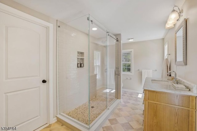 bathroom featuring vanity, tile patterned floors, and a shower stall