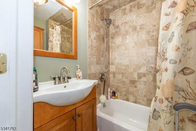 bathroom featuring vanity and shower / bathtub combination with curtain