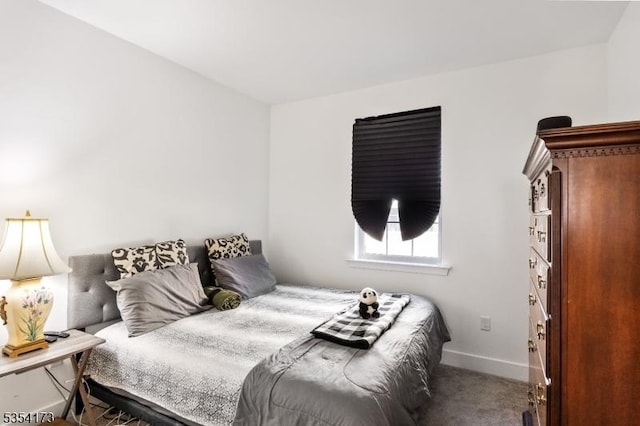 carpeted bedroom featuring baseboards