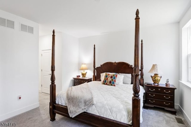 carpeted bedroom featuring baseboards and visible vents