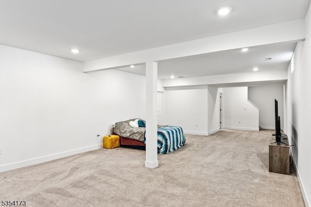 interior space featuring recessed lighting, baseboards, and light carpet