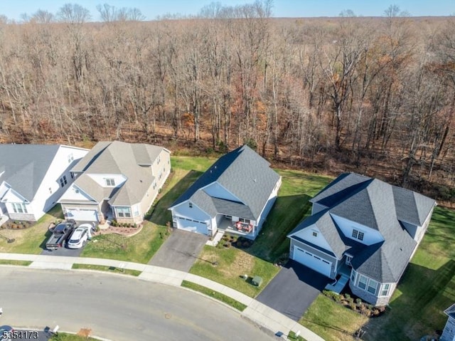 bird's eye view featuring a view of trees and a residential view