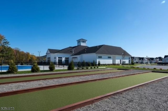 view of community featuring fence and a residential view
