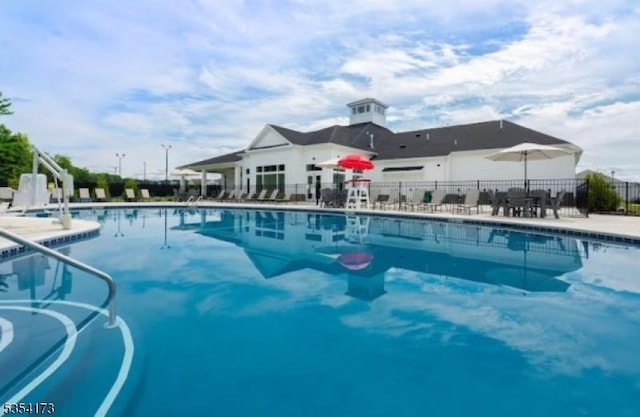 pool featuring a patio area and fence