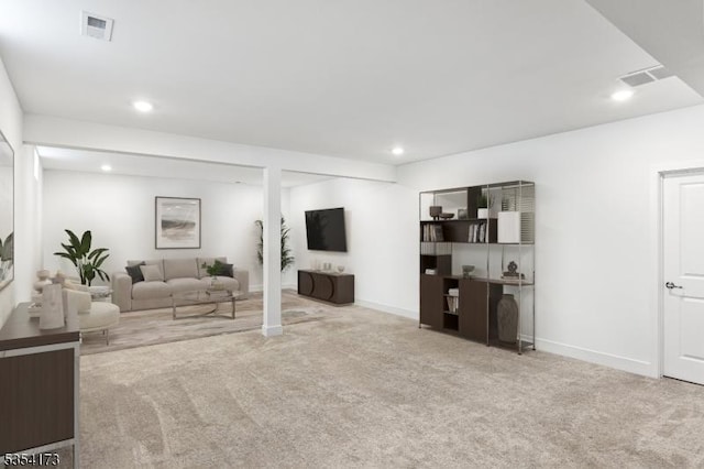 living area with visible vents, recessed lighting, and carpet floors