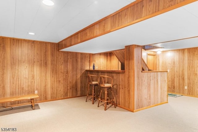 bar featuring carpet floors, recessed lighting, wood walls, and a dry bar