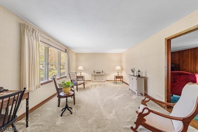 living area with baseboards, carpet, and visible vents