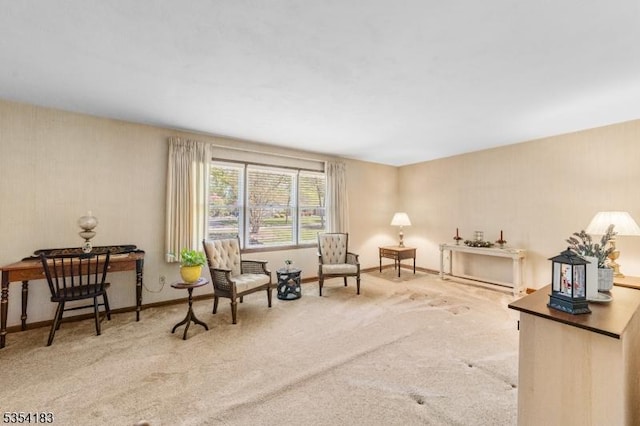 living area featuring carpet floors and baseboards