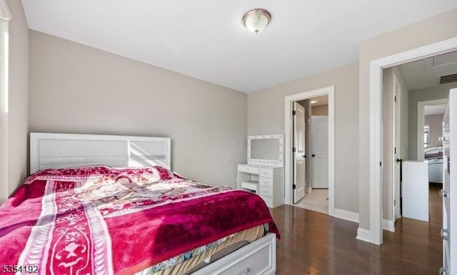 bedroom featuring baseboards and wood finished floors