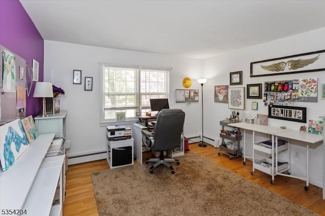 home office with a baseboard heating unit and wood finished floors