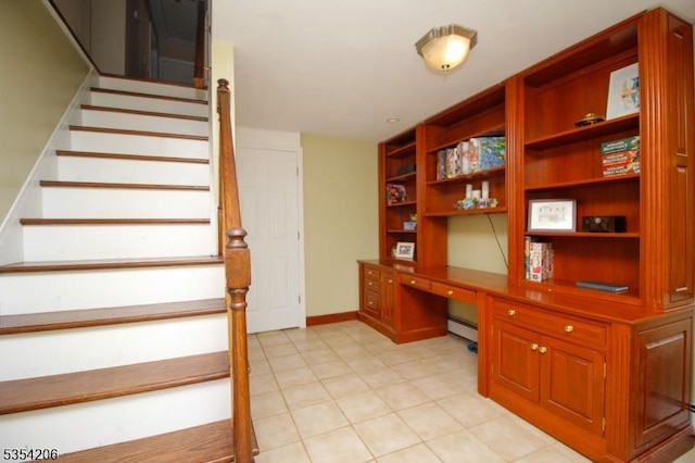 unfurnished office with light tile patterned floors, baseboards, a baseboard heating unit, and built in desk