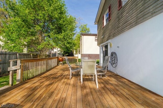 wooden deck featuring fence and outdoor dining area