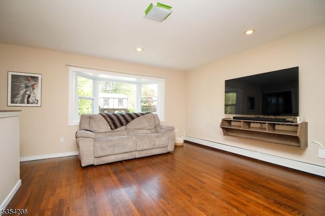 living room with baseboards, a baseboard radiator, wood finished floors, and visible vents