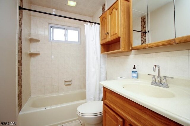 full bath with vanity, decorative backsplash, shower / bath combo with shower curtain, and toilet