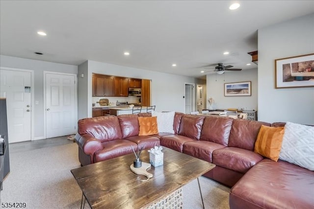 living area featuring ceiling fan and recessed lighting