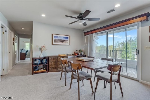 dining space with recessed lighting, visible vents, light carpet, and a wealth of natural light