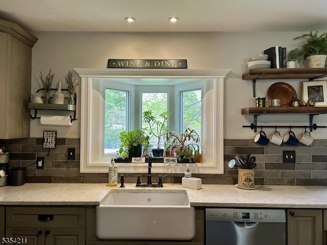 kitchen with stainless steel dishwasher, open shelves, gray cabinets, a sink, and backsplash