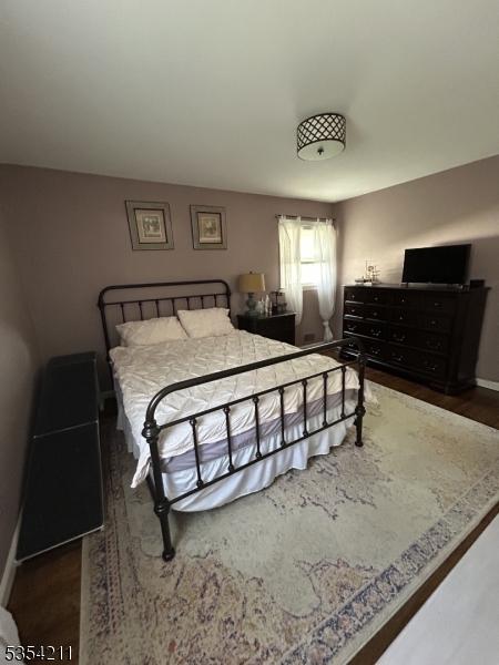 bedroom featuring baseboards and wood finished floors