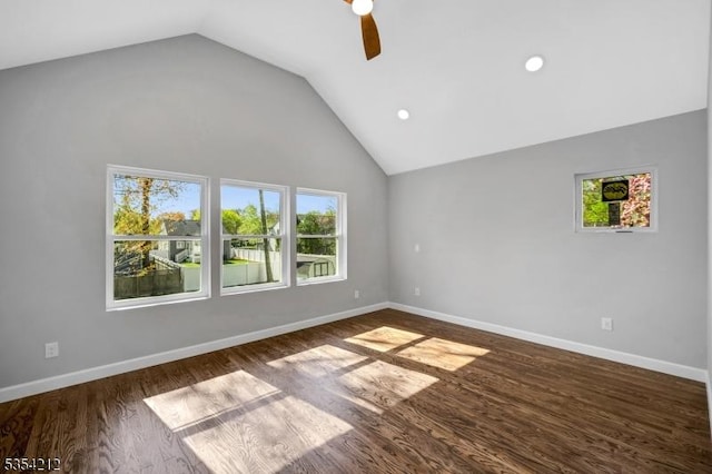 unfurnished room with dark wood finished floors, ceiling fan, vaulted ceiling, and a healthy amount of sunlight