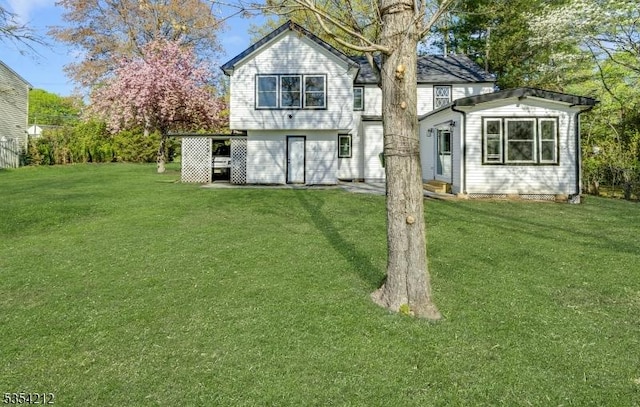 back of property featuring a yard