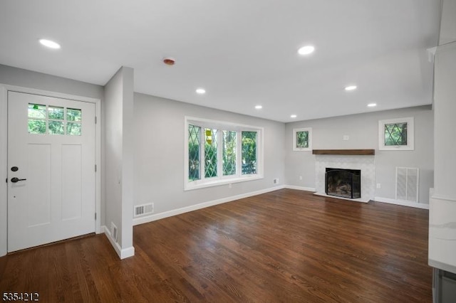 unfurnished living room with recessed lighting, baseboards, visible vents, and wood finished floors