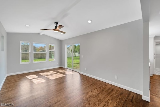 empty room featuring baseboards, lofted ceiling with beams, a ceiling fan, and wood finished floors