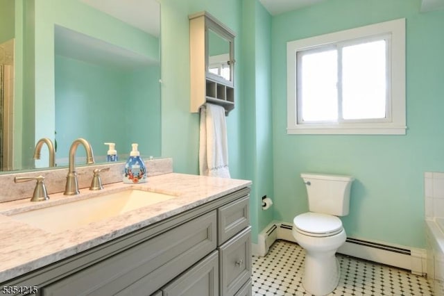 bathroom with vanity, toilet, a bathtub, and a baseboard radiator
