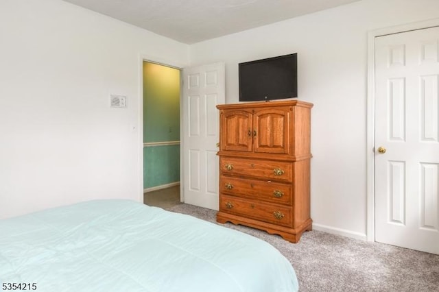bedroom featuring baseboards and light colored carpet