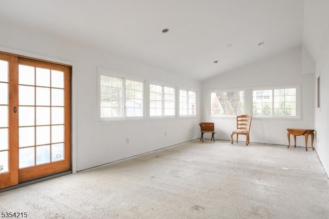 sitting room with carpet floors, vaulted ceiling, and plenty of natural light