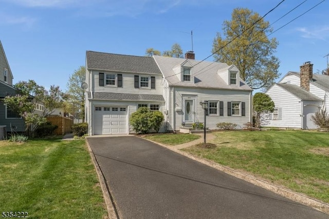 view of front facade with a garage, driveway, a front yard, and cooling unit