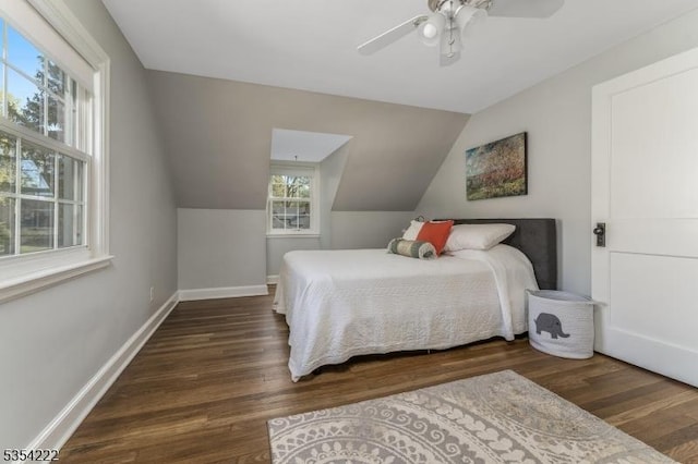 bedroom with baseboards, ceiling fan, vaulted ceiling, and wood finished floors