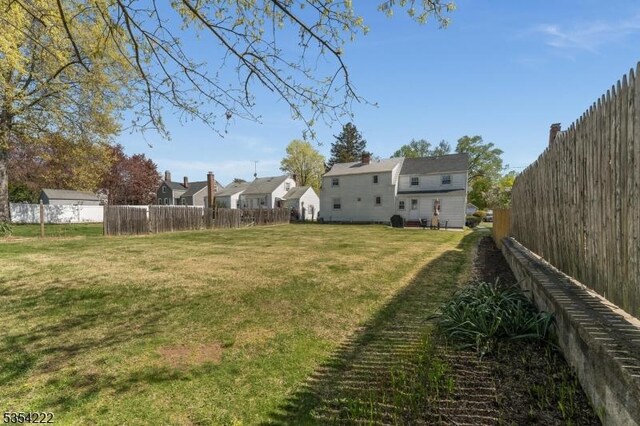 view of yard with a residential view and a fenced backyard