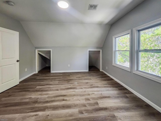 bonus room featuring baseboards, vaulted ceiling, and visible vents