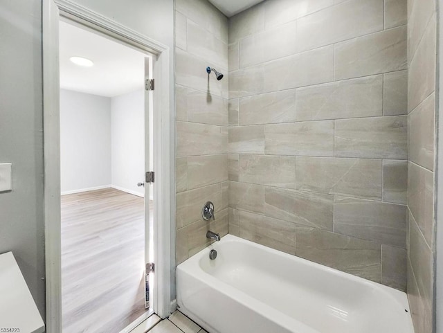 full bath with shower / bathtub combination, baseboards, and wood finished floors