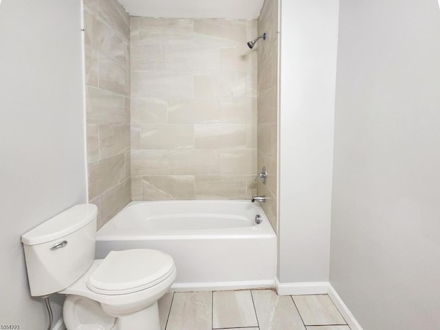 bathroom with baseboards, tile patterned floors, shower / bathtub combination, and toilet