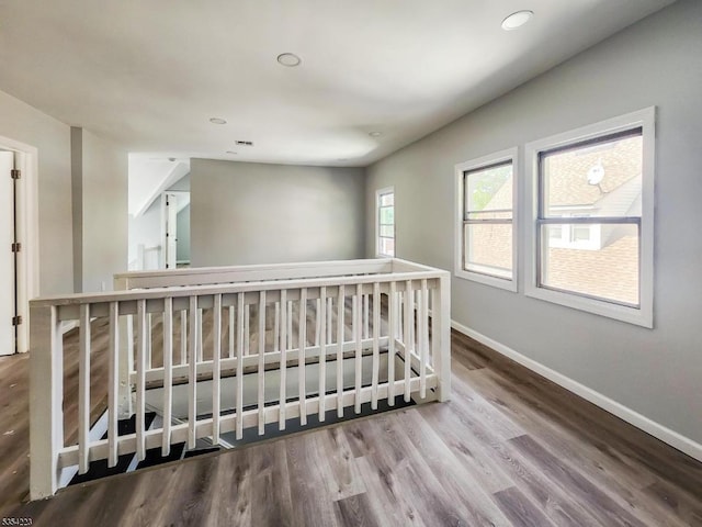 interior space with baseboards, recessed lighting, and wood finished floors