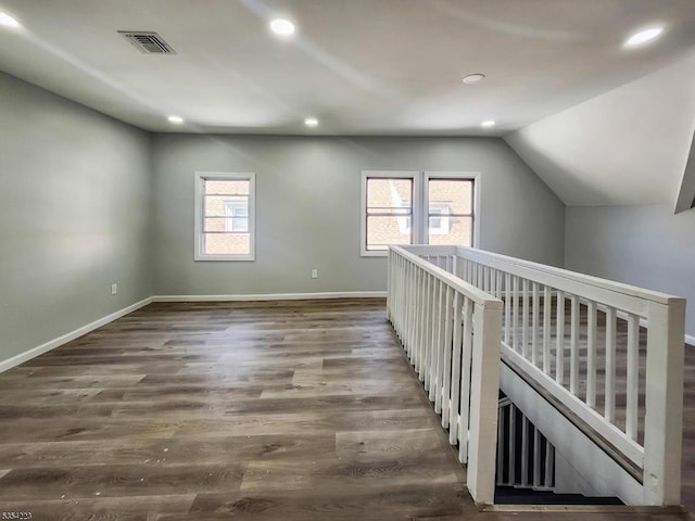 additional living space featuring visible vents, recessed lighting, lofted ceiling, and wood finished floors