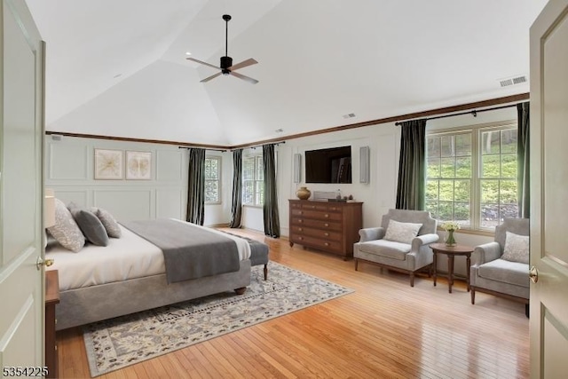 bedroom featuring high vaulted ceiling, ceiling fan, light wood finished floors, and visible vents