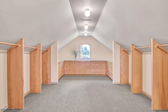 additional living space with visible vents, baseboards, lofted ceiling, and light colored carpet