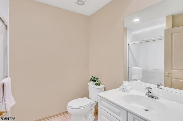 bathroom featuring a shower with shower door, tile patterned flooring, vanity, toilet, and visible vents